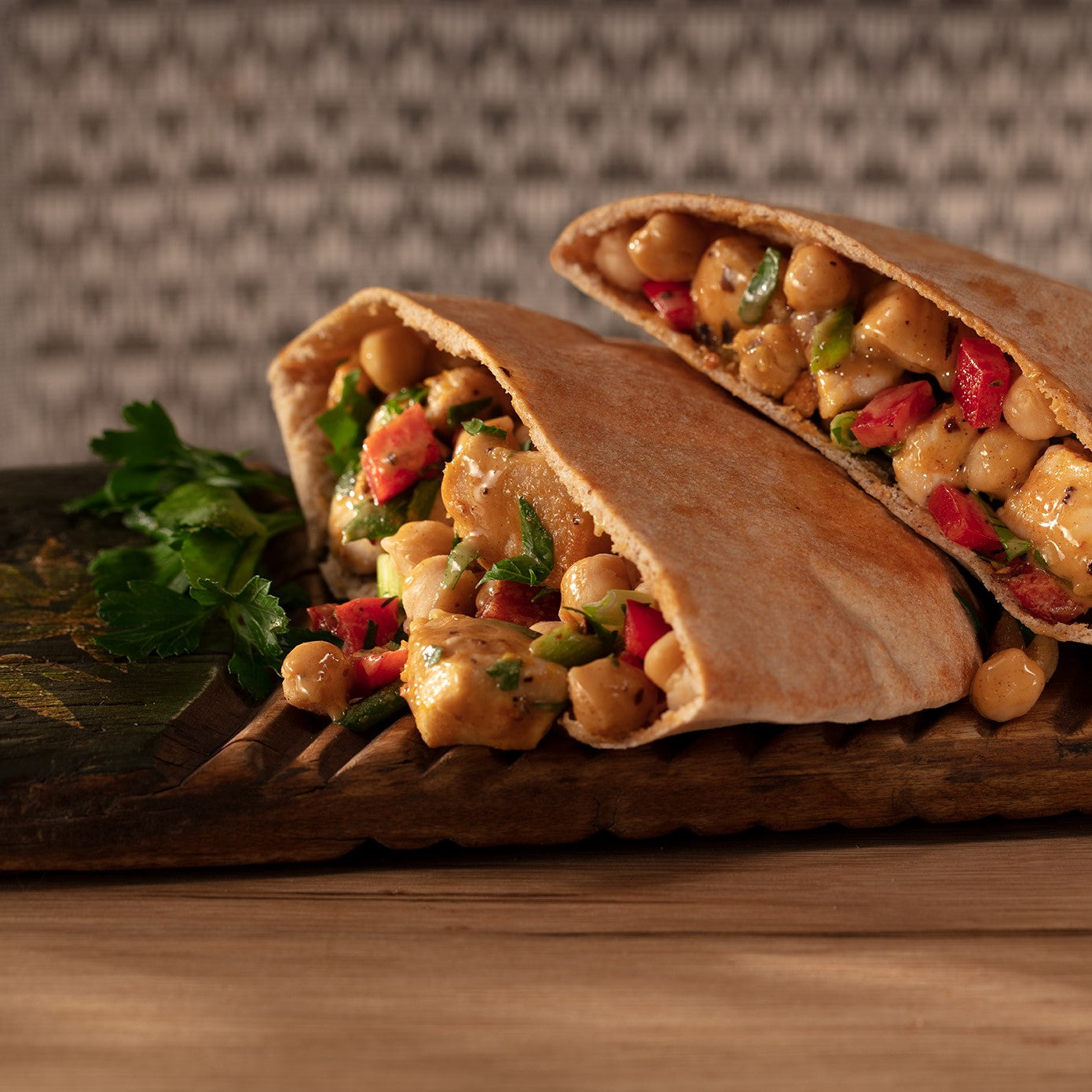 Pita pockets with chicken, garbanzo beans, red peppers, scallions and lemon tahini oo’mämē dressing.