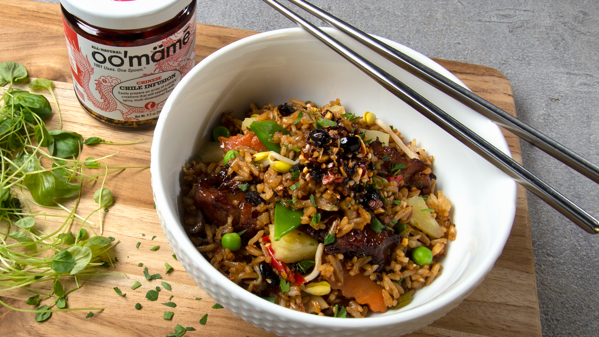 White bowl with chopsticks and fried rice with vegetables and oo’mämē. Jar of Chinese oo’mämē. #fried rice #myoomame