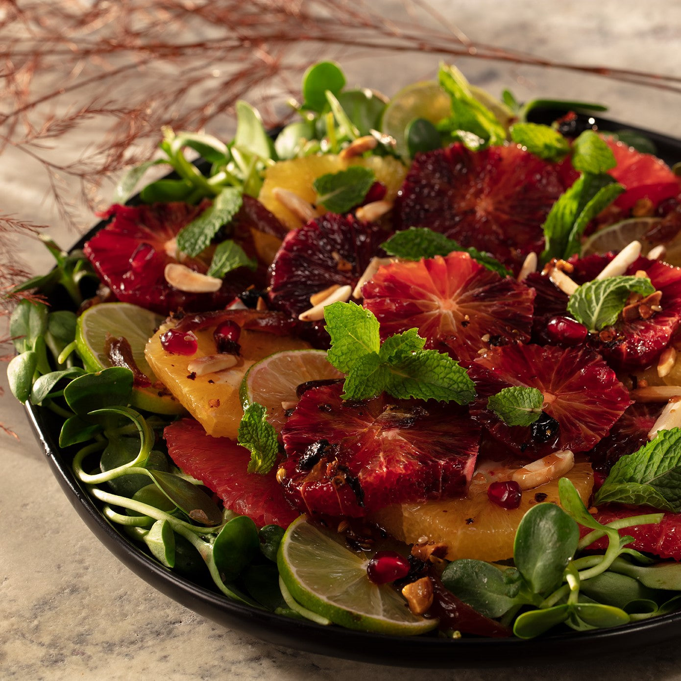 Citrus salad of blood orange, navel orange, pink grapefruit and limes with pomegranate molasses oo’mämē Chile Crisp, fresh mint, pomegranate arils and dates