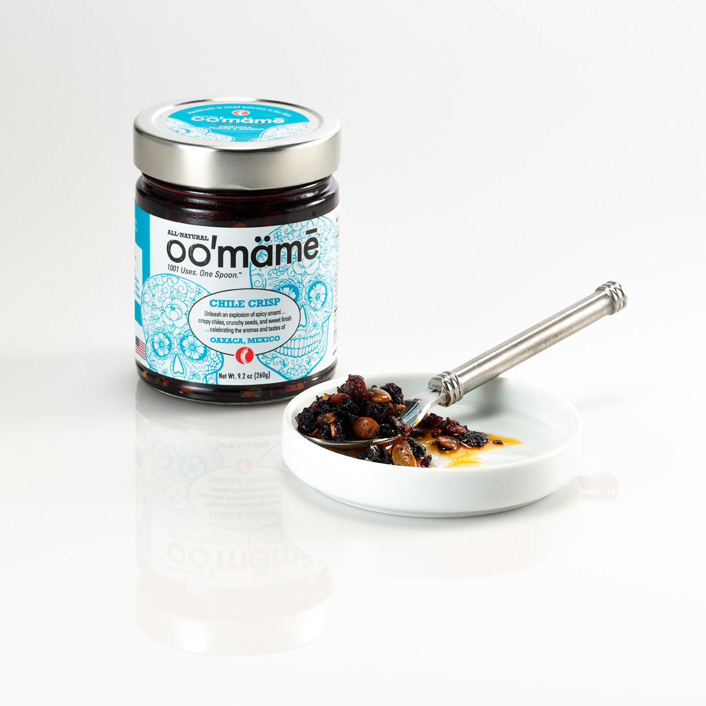 Jar of oo’mämē Mexican Chile Crisp with a spoonful of oo’mämē