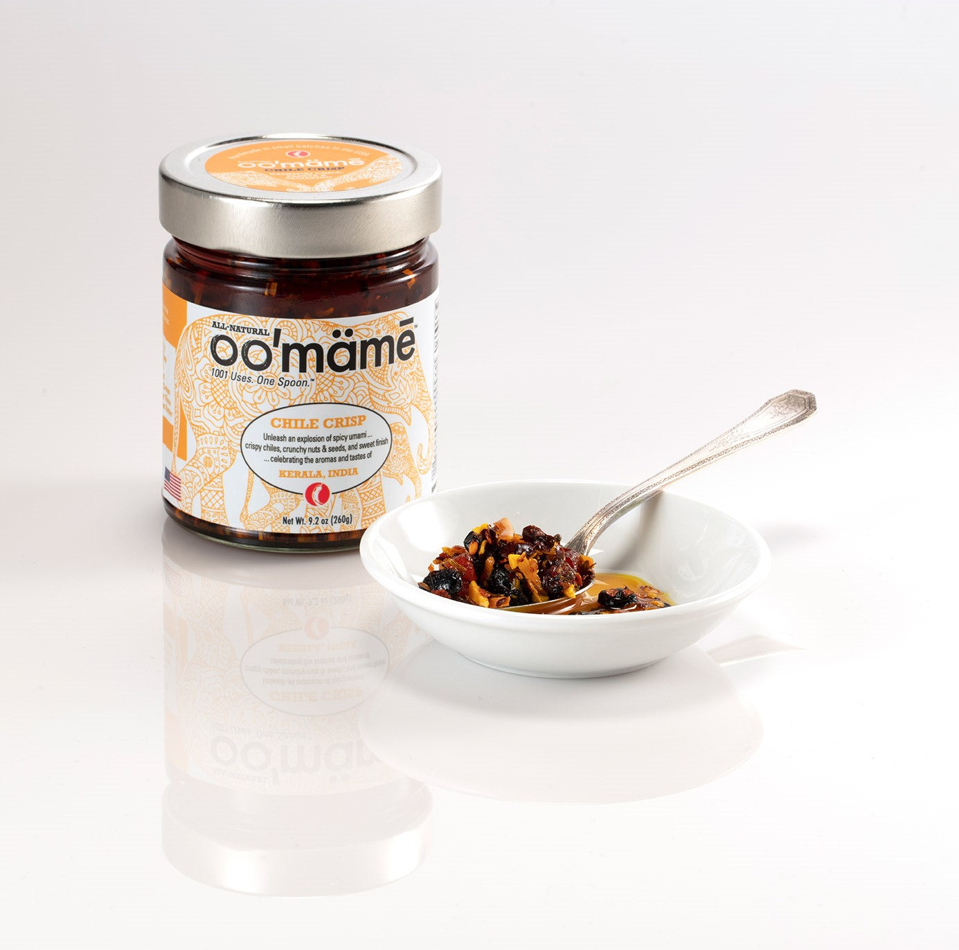 Jar of oo’mämē Indian Chile Crisp with a spoonful of oo’mämē