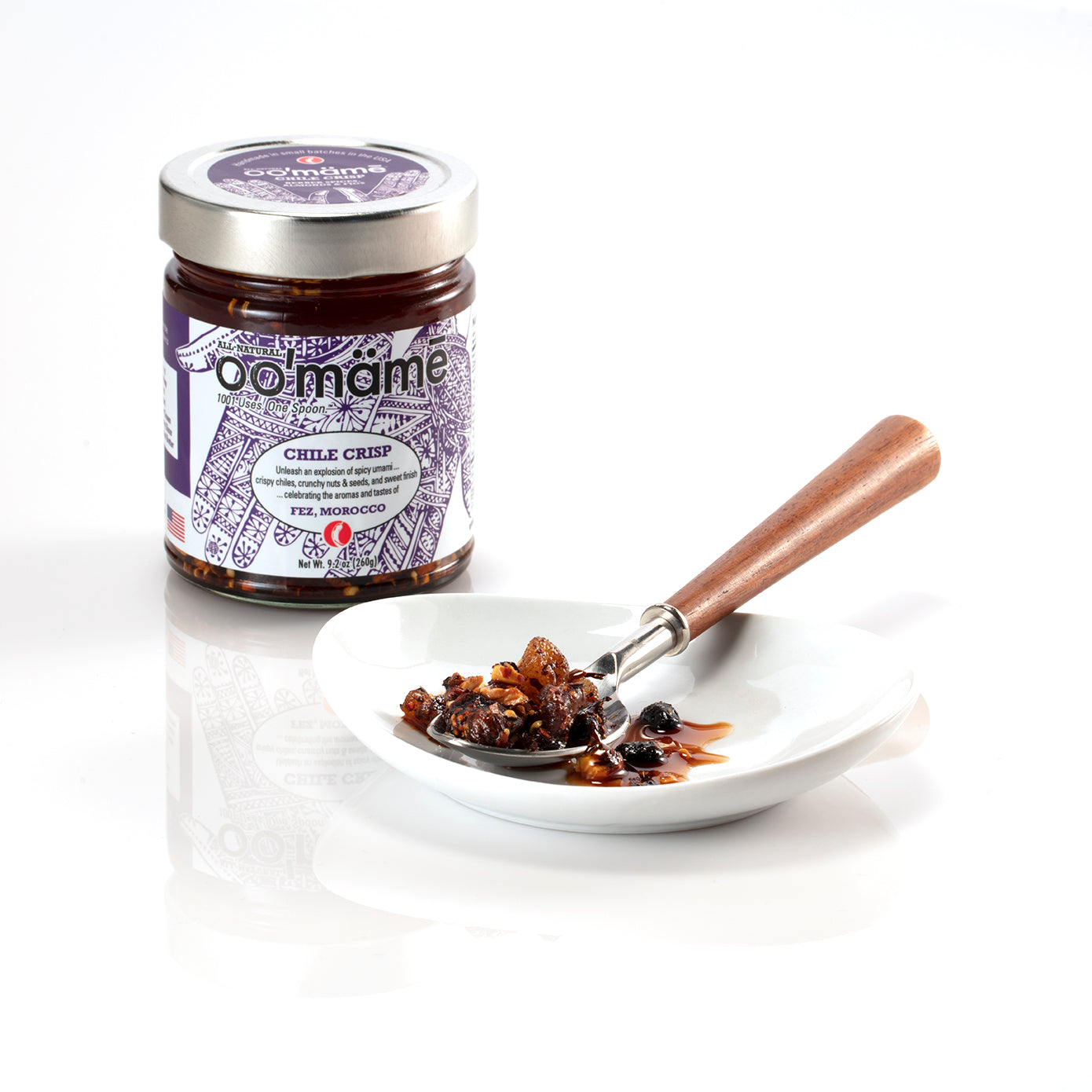 Jar of oo’mämē Moroccan Chile Crisp with a spoonful of oo’mämē
